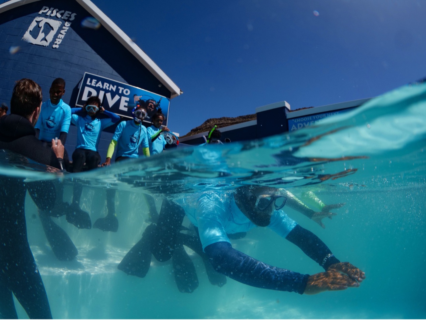 Marine Explorers learn how to use a mask and snorkel in the safety of the Pisces Divers swimming pool in Simonstown before heading into the ocean. Image by Danel Wentzel.