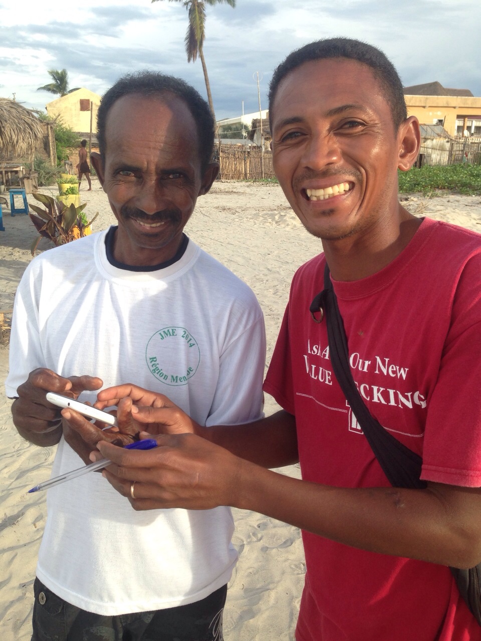  Farakely (left) and Emmanuel pose with the smartphone after Farakely has successfully learnt to collect data. © Dan Berrara