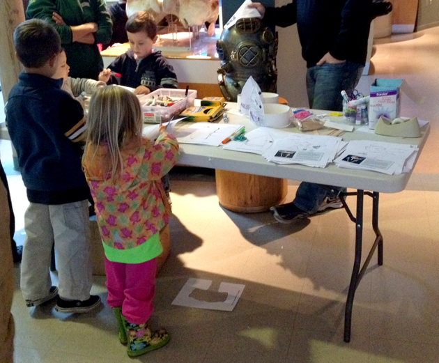 Kids make shark hats and bookmarks during Shark Day!